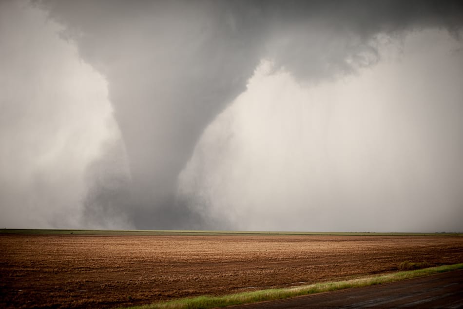A tornado about to strike in an open field.
