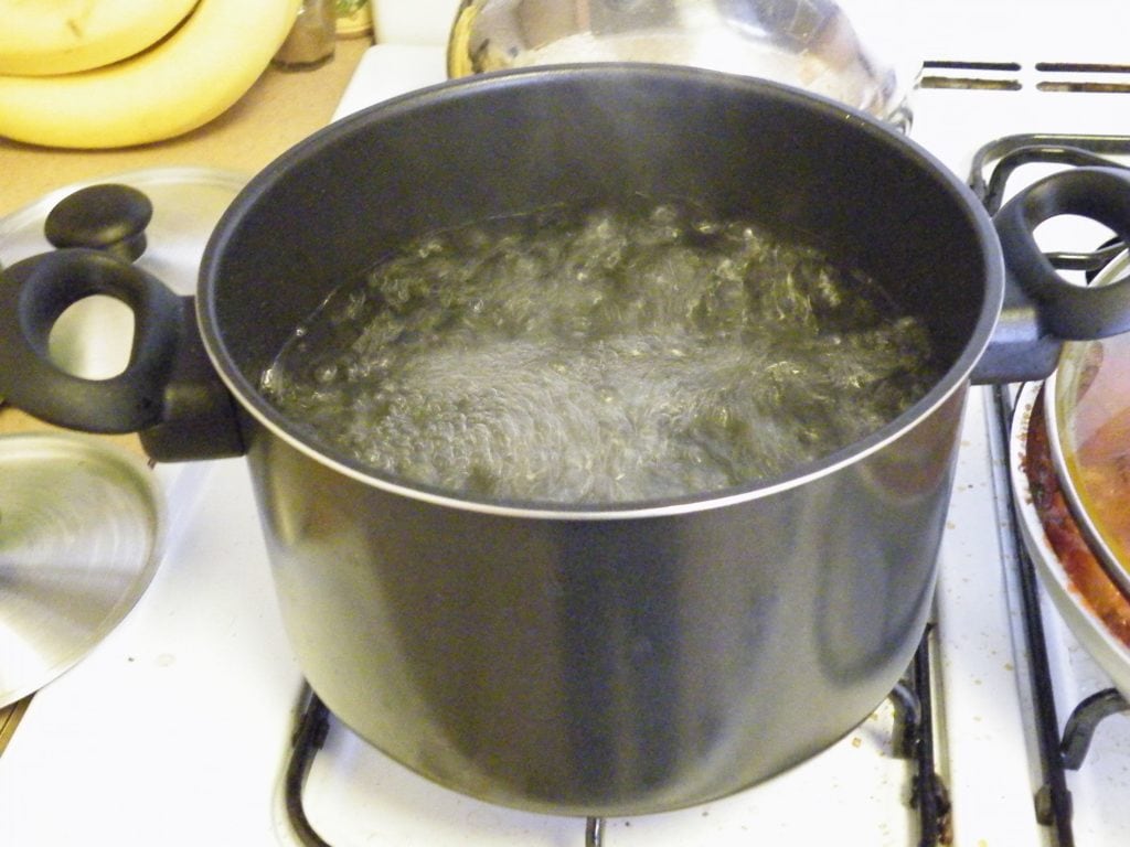 Boiling pot of water on the stove.