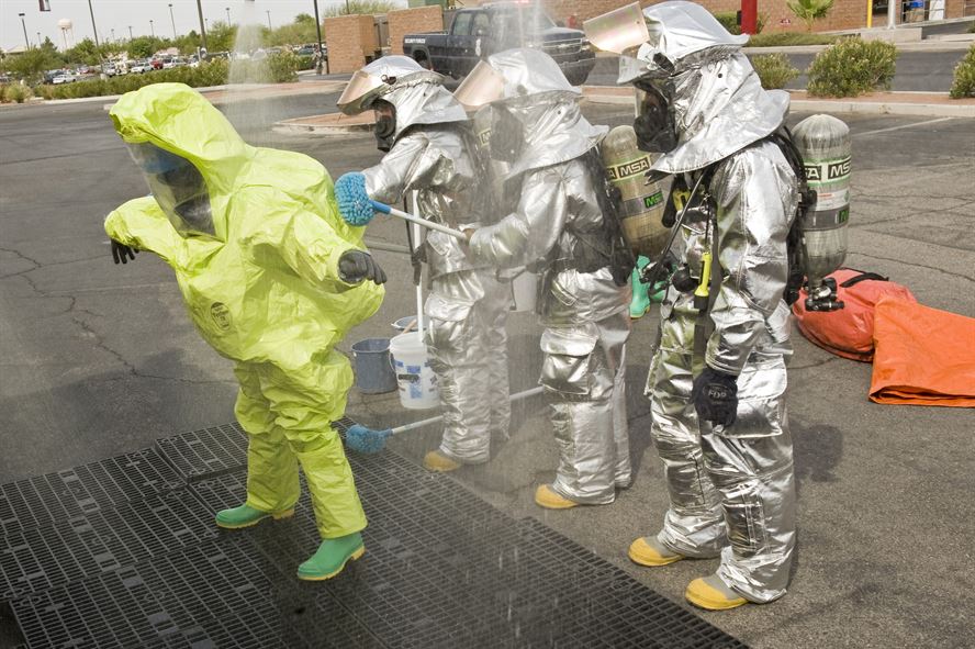 Emergency personnel performing decontamination. 