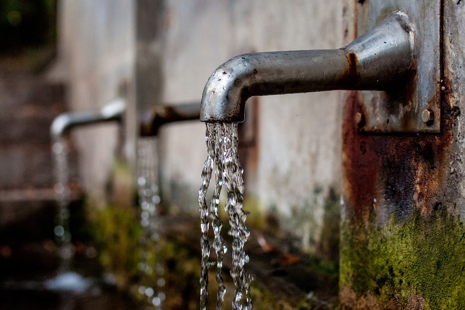 Water being dispensed from water barrels.
